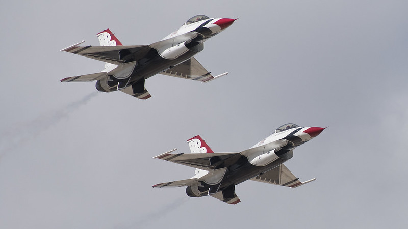 two fighter jets flying through the sky